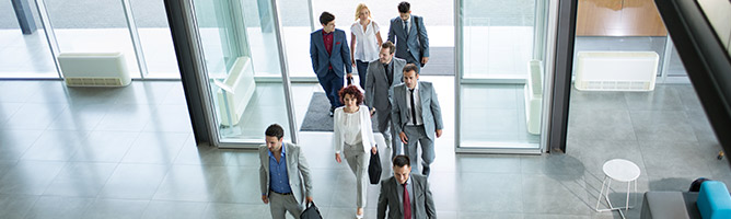 Group of business people entering a building
