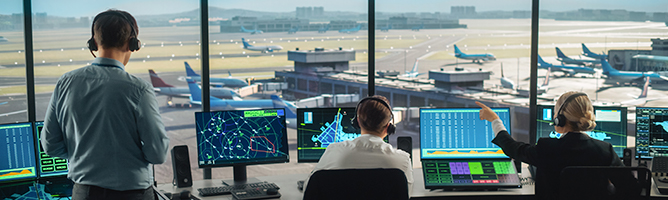 two people inside an air traffic control center